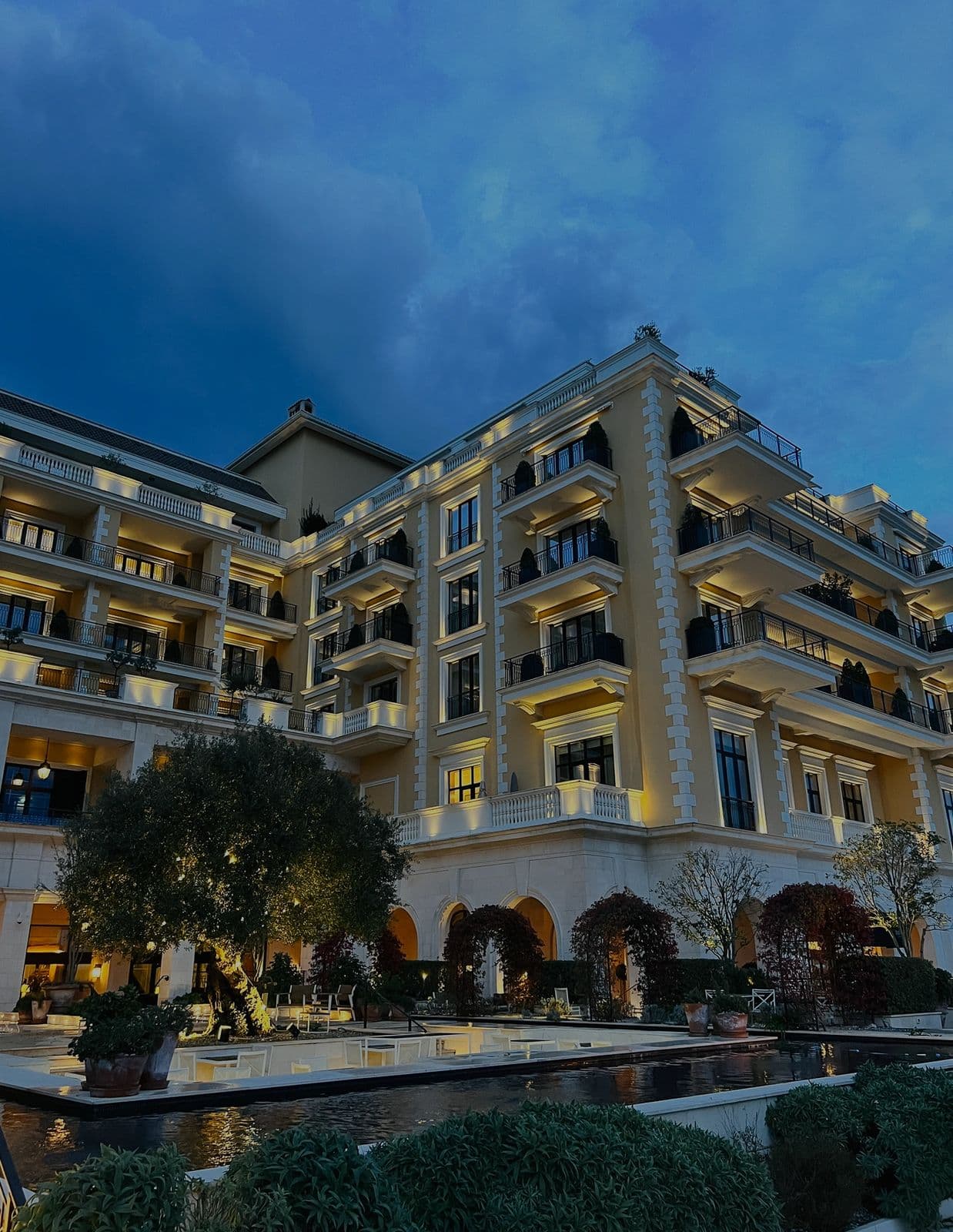Grand hotel lit up at dusk