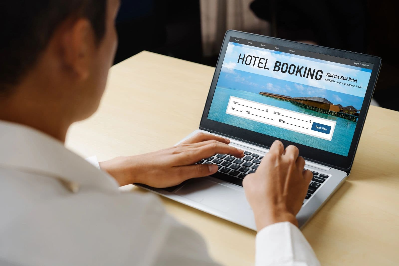 Traveller planning a hotel booking on a laptop