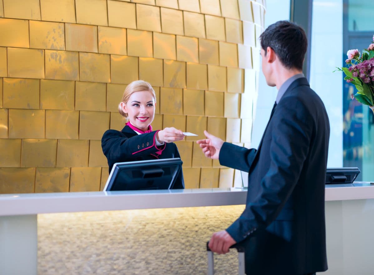 Front desk team checking in a hotel guest